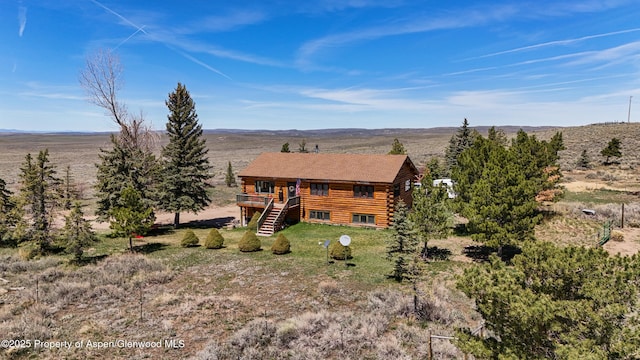 31 Ridge Dr, Craig, CO 81625 - rear view of house featuring a deck, stairway, log exterior, and a view of countryside