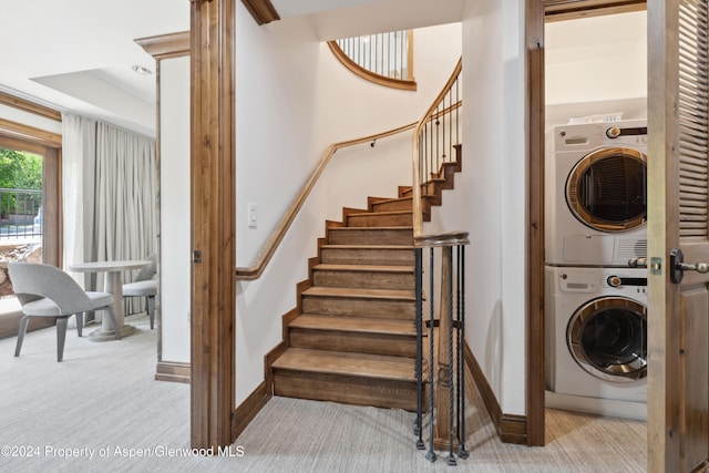 laundry room with stacked washer / dryer and light carpet