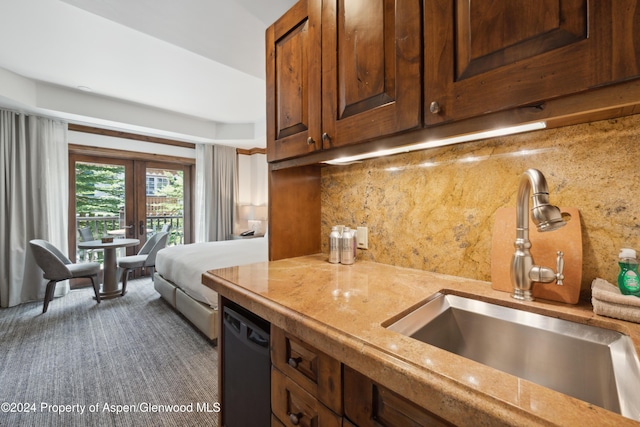 kitchen featuring black dishwasher, french doors, sink, and tasteful backsplash