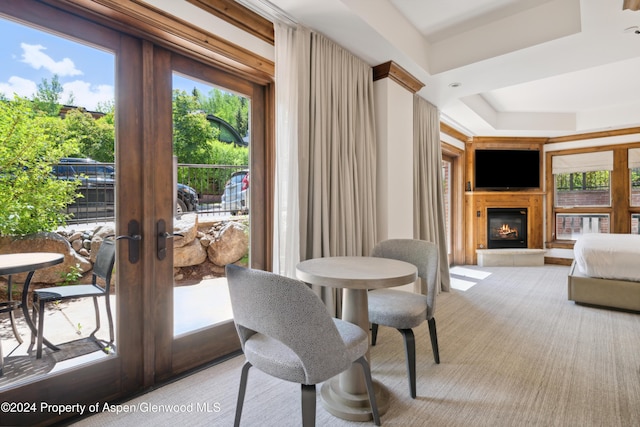 dining room with a raised ceiling and french doors