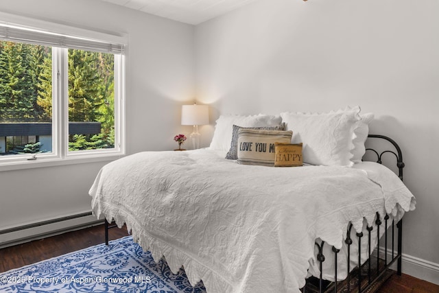 1024 E Cooper Ave Unit 8, Aspen, CO 81611 - bedroom with a baseboard heating unit and wood finished floors