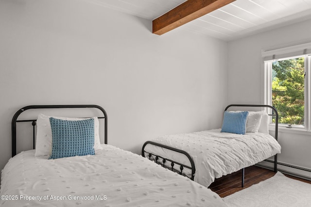 1024 E Cooper Ave Unit 8, Aspen, CO 81611 - bedroom with beam ceiling, wood finished floors, and a baseboard radiator