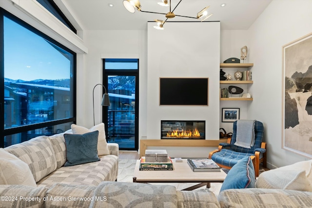 living room with light wood-type flooring and an inviting chandelier