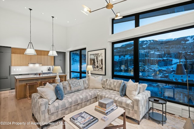 119 Wood Rd Unit 601, Snowmass Village, CO 81615 - living room featuring a high ceiling and light wood finished floors