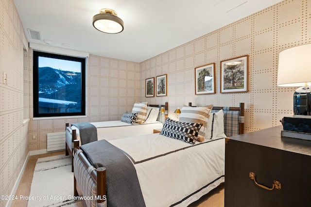 119 Wood Rd Unit 601, Snowmass Village, CO 81615 - bedroom featuring wood finished floors and wallpapered walls