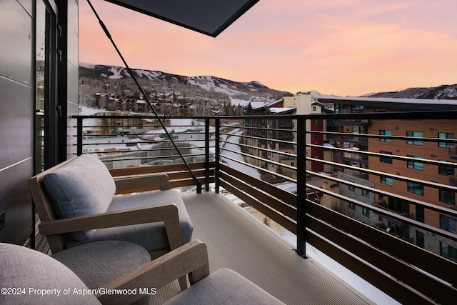 119 Wood Rd Unit 601, Snowmass Village, CO 81615 - balcony at dusk featuring a mountain view