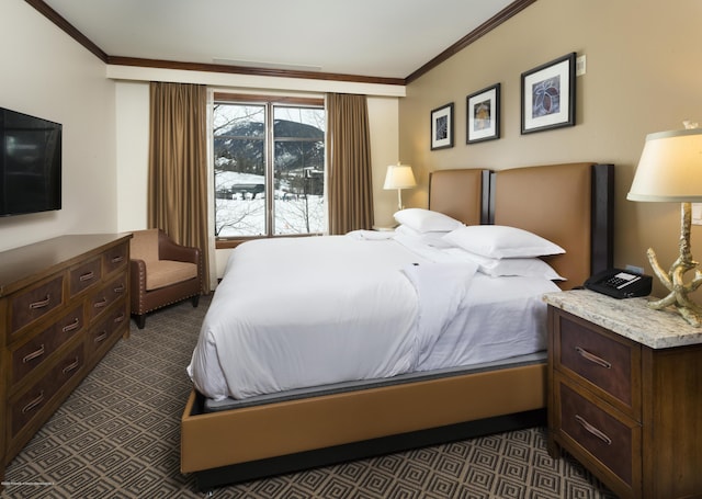 bedroom featuring dark colored carpet and ornamental molding