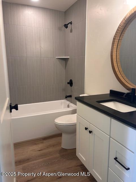 326 W 30th St, Rifle, CO 81650 - full bathroom with toilet, wood finished floors, shower / bathtub combination, and vanity