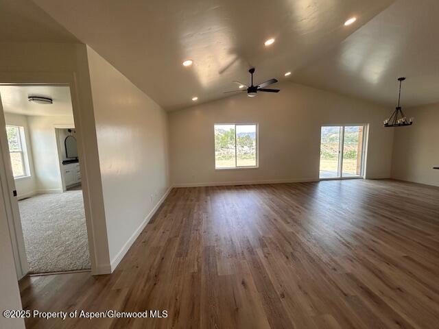 326 W 30th St, Rifle, CO 81650 - unfurnished room with a chandelier, wood finished floors, a ceiling fan, baseboards, and lofted ceiling
