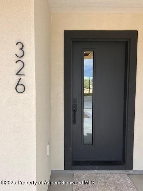 326 W 30th St, Rifle, CO 81650 - doorway to property featuring stucco siding