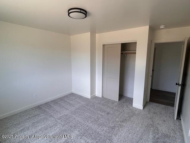326 W 30th St, Rifle, CO 81650 - unfurnished bedroom featuring carpet flooring, a closet, and baseboards