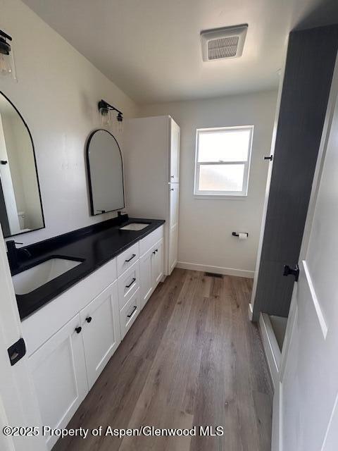 326 W 30th St, Rifle, CO 81650 - full bath with wood finished floors, double vanity, and baseboards