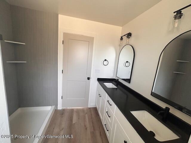 326 W 30th St, Rifle, CO 81650 - full bathroom featuring wood finished floors and double vanity