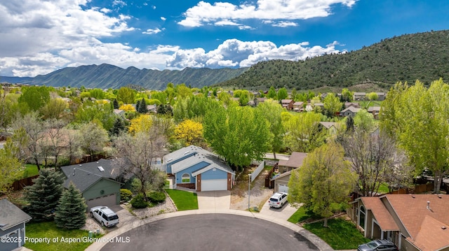 aerial perspective of suburban area featuring a mountain backdrop