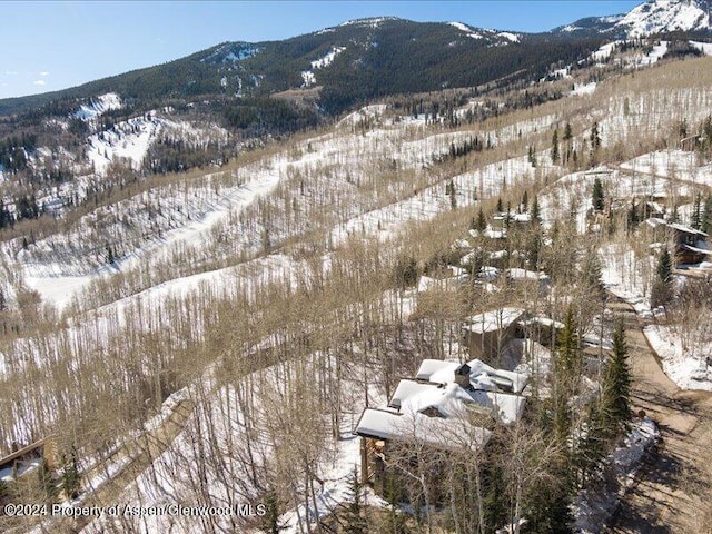 snowy aerial view with a mountain view