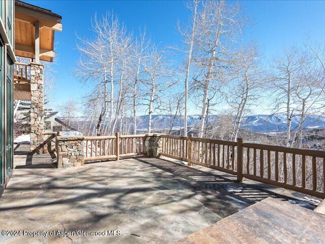 snow covered deck featuring a mountain view