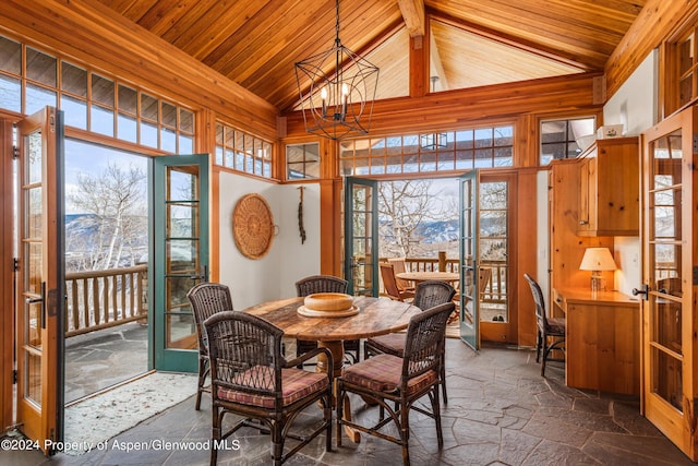 dining area with a mountain view, high vaulted ceiling, french doors, a wealth of natural light, and a notable chandelier