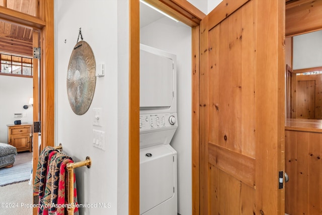 laundry room with stacked washing maching and dryer