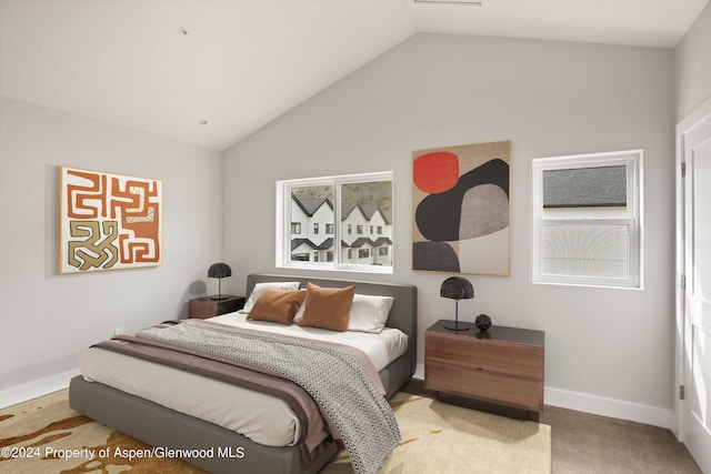 bedroom featuring carpet and lofted ceiling