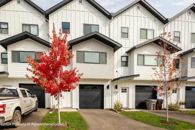 multi unit property featuring a garage