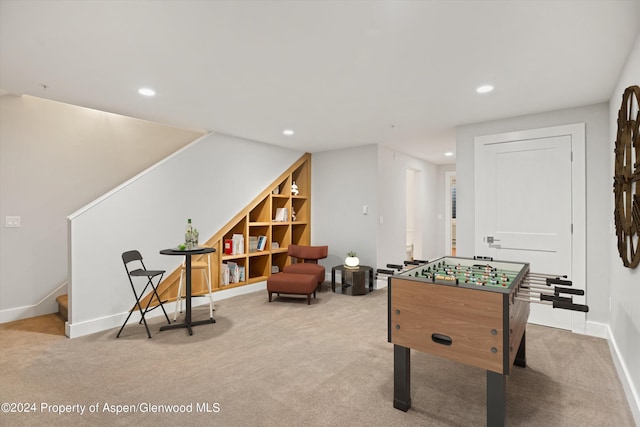 game room featuring light colored carpet