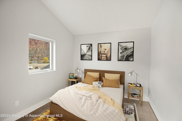 carpeted bedroom featuring vaulted ceiling