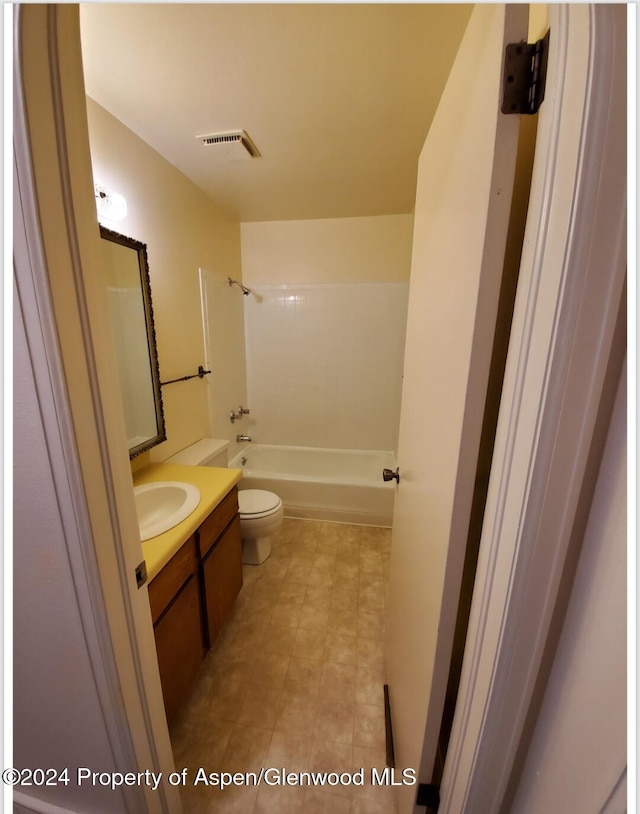 full bathroom with washtub / shower combination, vanity, and toilet