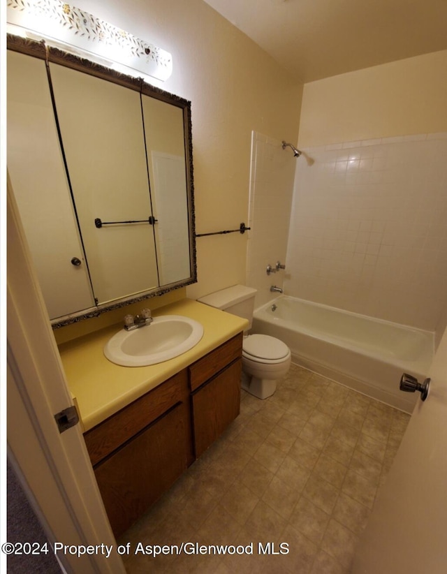 full bathroom with bathing tub / shower combination, vanity, and toilet