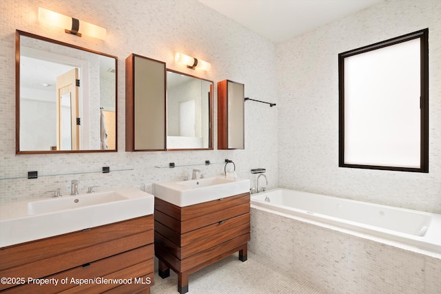 bathroom featuring vanity, tiled bath, and tile patterned floors