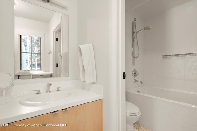 full bathroom featuring tile patterned flooring, vanity, toilet, and tiled shower / bath