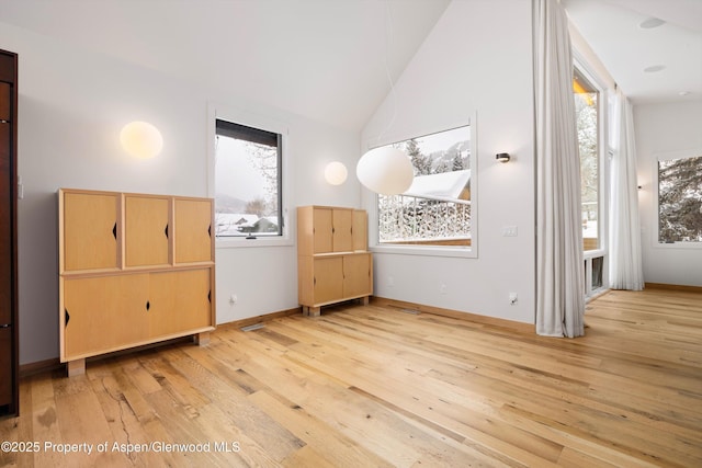 bedroom featuring light wood-type flooring and vaulted ceiling