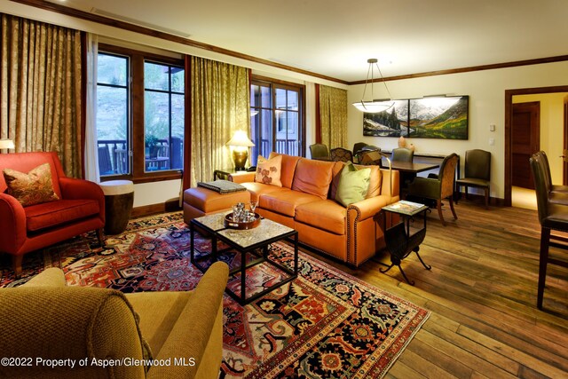 living room featuring wood-type flooring and ornamental molding