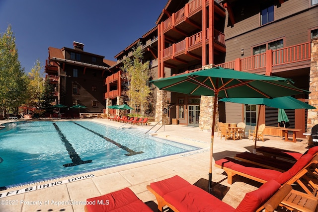 view of swimming pool featuring a patio area