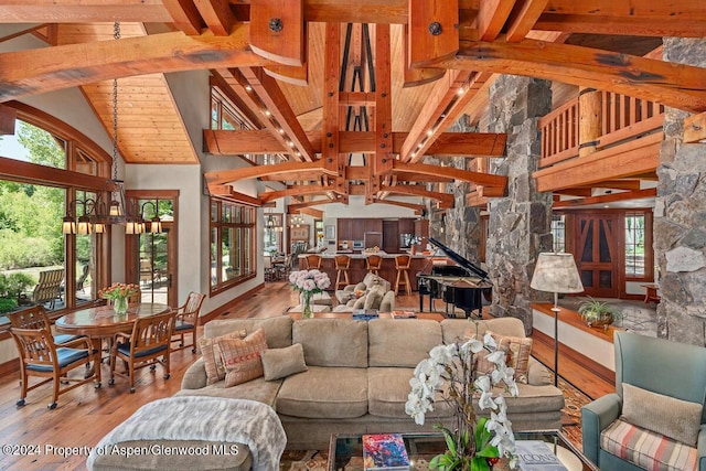 living room with high vaulted ceiling, an inviting chandelier, hardwood / wood-style flooring, beam ceiling, and wood ceiling