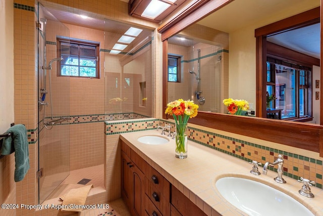 bathroom with decorative backsplash, vanity, and walk in shower