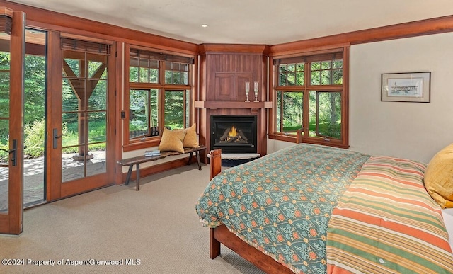 bedroom featuring access to outside, french doors, and light colored carpet