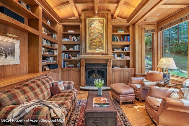 living area with light hardwood / wood-style floors, built in features, wooden walls, and wooden ceiling