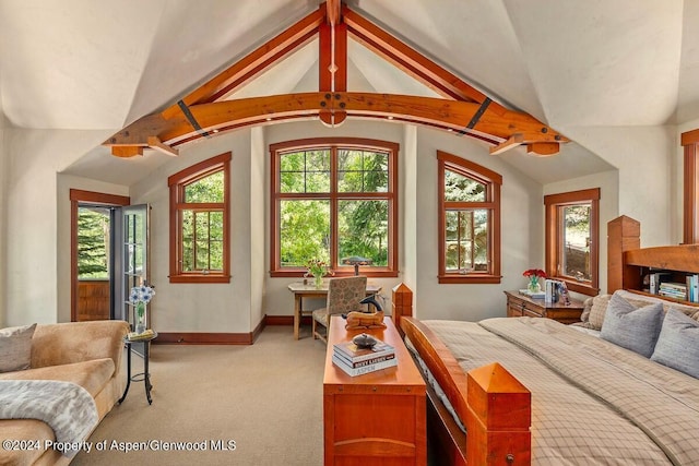 bedroom featuring light colored carpet, multiple windows, and lofted ceiling