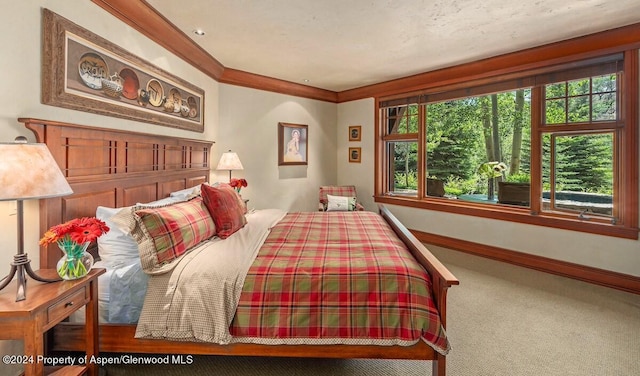 carpeted bedroom featuring crown molding