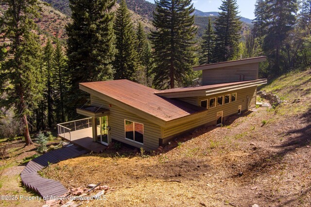 768 Kings Lake Rd, Basalt, CO 81621 - back of property featuring a forest view, a deck with mountain view, and metal roof
