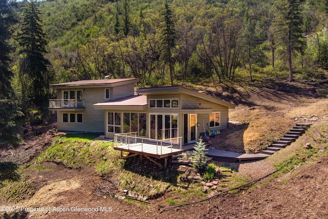 768 Kings Lake Rd, Basalt, CO 81621 - back of property with a wooded view, a balcony, a sunroom, and a wooden deck
