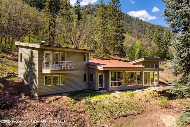 768 Kings Lake Rd, Basalt, CO 81621 - back of house with a balcony, a view of trees, and a sunroom