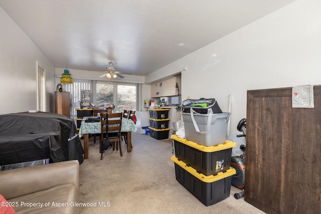 dining space featuring carpet and ceiling fan