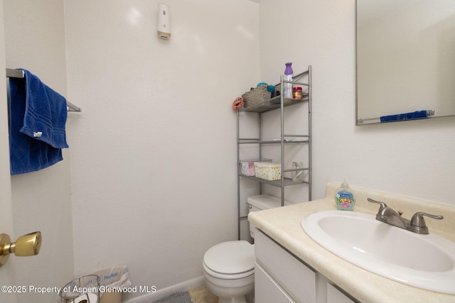 bathroom featuring vanity and toilet