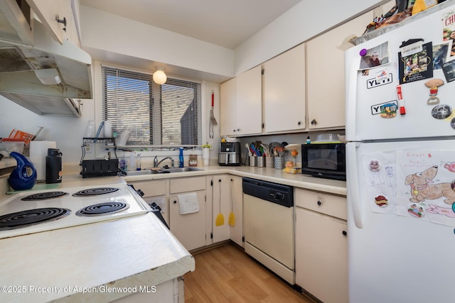 kitchen featuring white cabinetry, sink, white appliances, and light wood-type flooring