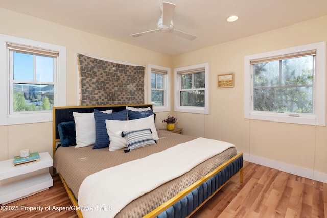 bedroom featuring wood finished floors, recessed lighting, baseboards, and ceiling fan