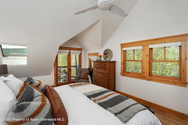 bedroom featuring access to outside, wood finished floors, lofted ceiling, baseboards, and a ceiling fan