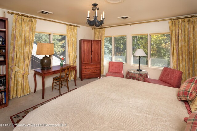 bedroom featuring carpet flooring and a chandelier