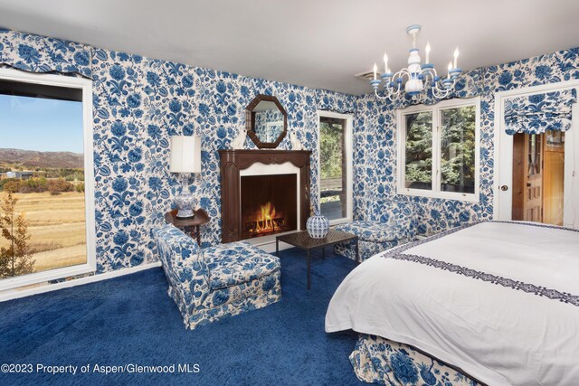 carpeted bedroom with a chandelier