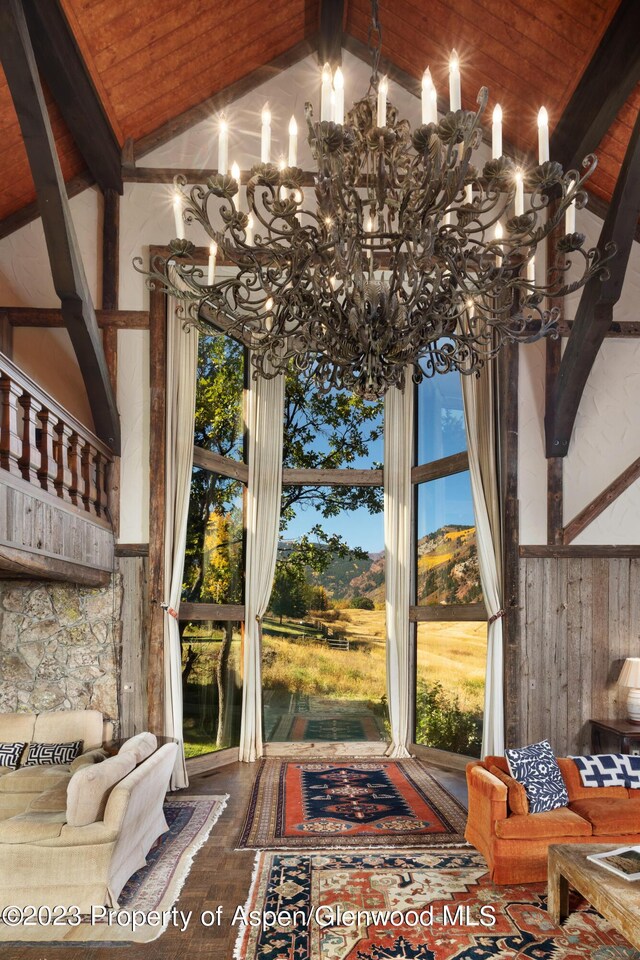 details featuring wood walls, beamed ceiling, wood ceiling, and a notable chandelier